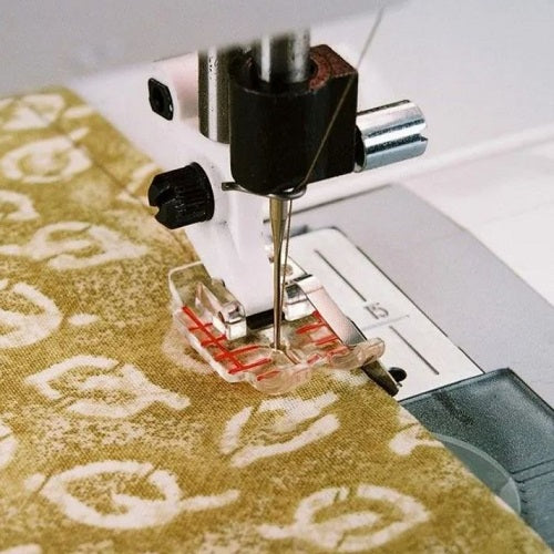 sewing a seam with the Husqvarna Viking Clear 1/4" Piecing Foot with Guide